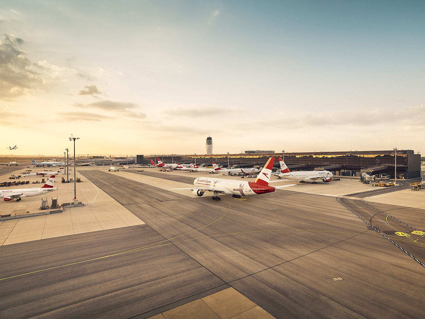 Foto: weiss rote Flugzeuge in Parkposition bei einem Flughafen